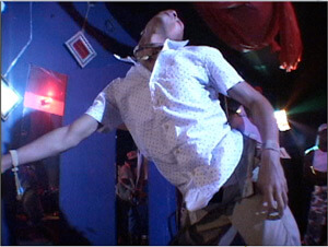 Video still from Ya Heard Me?, Matt Miller and Stephen Thomas, 2008. In the still, a dancer performs at a "sissy shakedown" at Club Vibe, New Orleans, Louisiana, 2004.