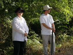 Ellen Schattschneider, Two reenactors playing Klansmen wait near the Moore's Ford Bridge, Walton County, Georgia, July 25, 2009. Ellen Schattschneider, Two reenactors playing Klansmen wait near the Moore's Ford Bridge, Walton County, Georgia, July 25, 2009.