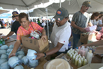 Andrea Booher, Evacuee Umberto Romero gathers food and necessities at the distribution center at the Chalmette Recovery Center set up following Hurricane Katrina, New Orleans, Louisiana, October 22, 2005. South Carolina Cares set up similar centers in Columbia, South Carolina. Andrea Booher, Evacuee Umberto Romero gathers food and necessities at the distribution center at the Chalmette Recovery Center set up following Hurricane Katrina, New Orleans, Louisiana, October 22, 2005. South Carolina Cares set up similar centers in Columbia, South Carolina.