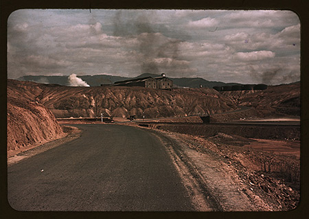 A train bringing copper ore out of the mine; fumes from smelting copper for sulfuric acid have destroyed all vegetation and eroded the land, Ducktown, Tennessee, 1939.