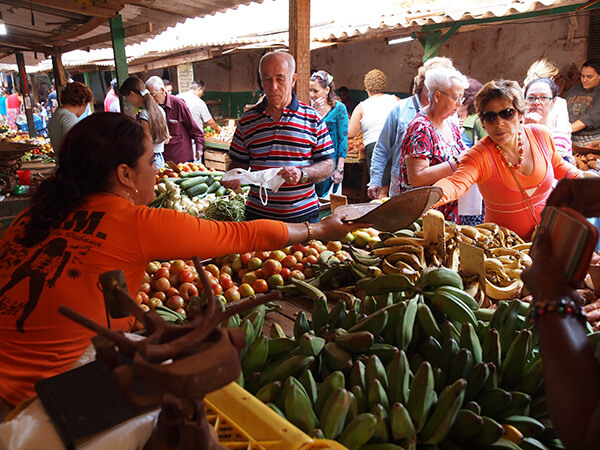 Charles D. Thompson, Jr., Osiris Cueto weighs produce for her customer at the Mercado Agropecuario Beleu. Old Havana, Cuba, December 2010. 