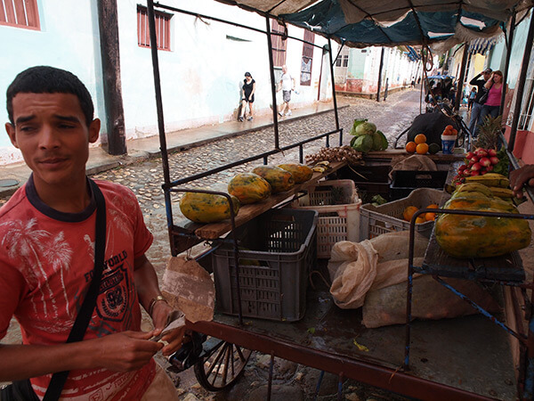 Charles D. Thompson, Jr., Tomás Pérez Ricardo, a recent graduate in agronomy, sells produce he raises on his own plot in downtown Trinidad, Cuba, January, 2010.