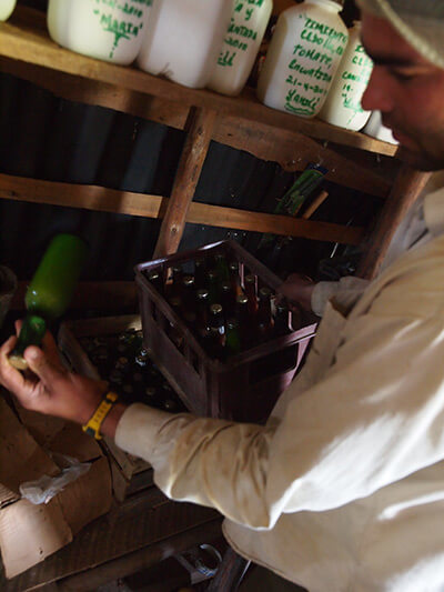 Charles D. Thompson, Jr., Royber Pimental Valido shows here some home bottled mango concentrate grown and processed on the farm. Pinar del Rio, Cuba, January 2011.