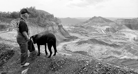 Mark Schmerling, Larry Gibson and his dog, "Dog," overlook the destruction at Kayford Mountain, Kanawha County, West Virgina, 2006.
