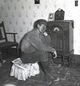 Marion Post Wolcott, A coal miner listens to his radio, 1938. Marion Post Wolcott, A coal miner listens to his radio, 1938.