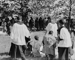 Russell Lee, Library of Congress, Prints & Photographs Division FSA-OWI Collection Reproduction Number: LC-USF33-011901-M2 DLC, Catholic priests blessing members of their congregation, New Roads, Louisiana, 1938. Russell Lee, Library of Congress, Prints & Photographs Division FSA-OWI Collection Reproduction Number: LC-USF33-011901-M2 DLC, Catholic priests blessing members of their congregation, New Roads, Louisiana, 1938.