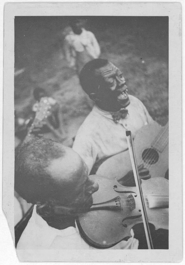 Wilson "Stavin' Chain" Jones playing guitar and singing the ballad "Batson" alongside fiddler Octave Amos, Lafayette, Louisiana, 1934. Photograph by Alan Lomax. The Lomax Collection, Library of Congress. Courtesy of The Library of Congress, Prints and Photographs Division, LC-DIG-ppmsc-00340. Wilson "Stavin' Chain" Jones playing guitar and singing the ballad "Batson" alongside fiddler Octave Amos, Lafayette, Louisiana, 1934. Photograph by Alan Lomax. The Lomax Collection, Library of Congress. Courtesy of The Library of Congress, Prints and Photographs Division, LC-DIG-ppmsc-00340.