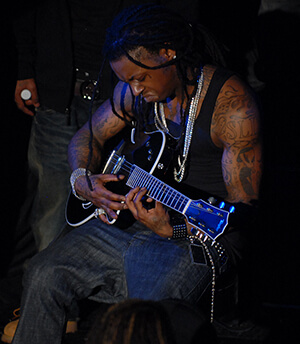 Lil Wayne plays the guitar, Washington, DC, January 15, 2008. Photograph by Flickr user Georgetown Voice. Courtsey of Georgetown Voice, Creative Commons License CC-BY-NC-SA 2.0.