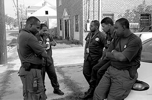 New Orleans police officers, off St. Claude Avenue. New Orleans, Louisiana, October 2005. Photograph by Lewis Watts. Courtesy Lewis Watts.