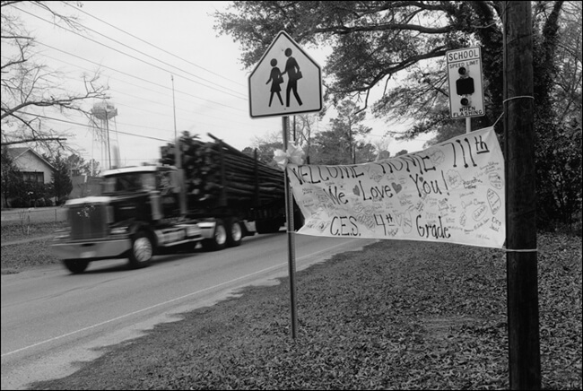 David Wharton, Welcome home and logging truck, Mississippi, 2005.