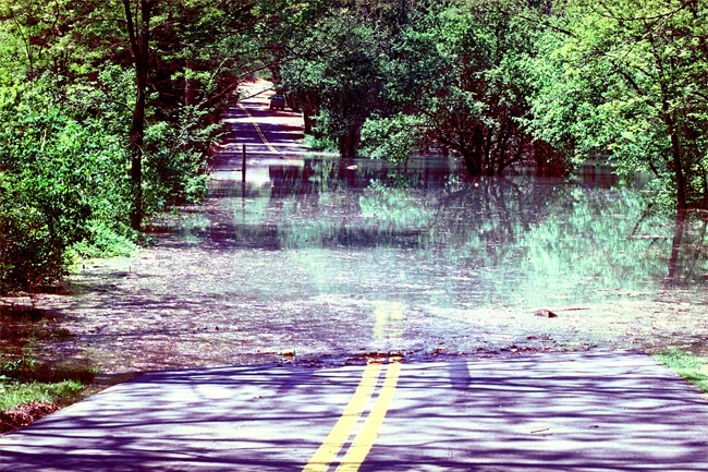 David Schwab, High water on access road, Grafton, West Virginia, 1987, Courtesy of the Army Corps of Engineers.