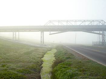 Pipeline and River Road, Donaldsonville, Louisiana, 2010. Photograph by Richard Misrach. Courtesy of Pace/MacGill Gallery, New York; Fraenkel Gallery, San Francisco; and Marc Selwyn Gallery, Los Angeles. © Richard Misrach. Pipeline and River Road, Donaldsonville, Louisiana, 2010. Photograph by Richard Misrach. Courtesy of Pace/MacGill Gallery, New York; Fraenkel Gallery, San Francisco; and Marc Selwyn Gallery, Los Angeles. © Richard Misrach.