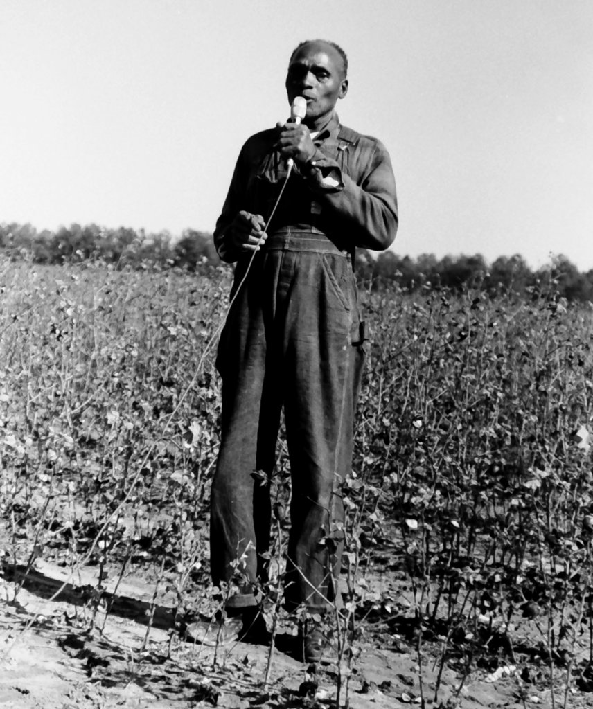 Cliff Davis singing in a field, holding a microphone.