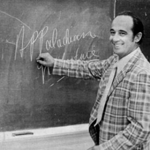 Black and white photograph of Jim Miller writing "Appalachian literature" on a chalk board.