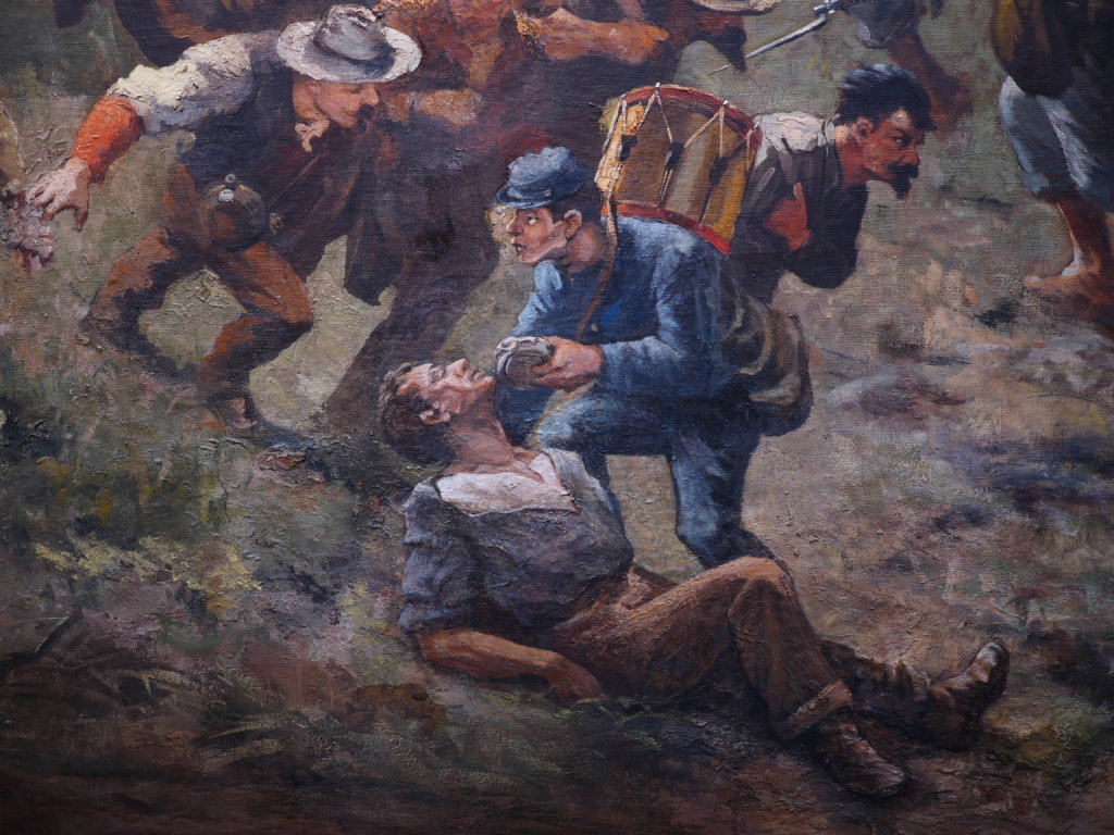 A federal army soldier shares his canteen with a wounded foe in the thick of combat
