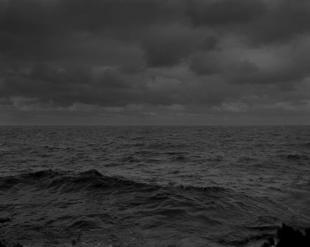 The waters of Lake Erie roll under a dark and cloudy sky.