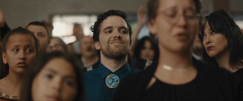 Danielle, Dollar, and Connie in a church pew during funeral service.