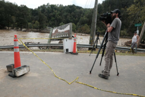 Media Videographer Reporting on Flooding.