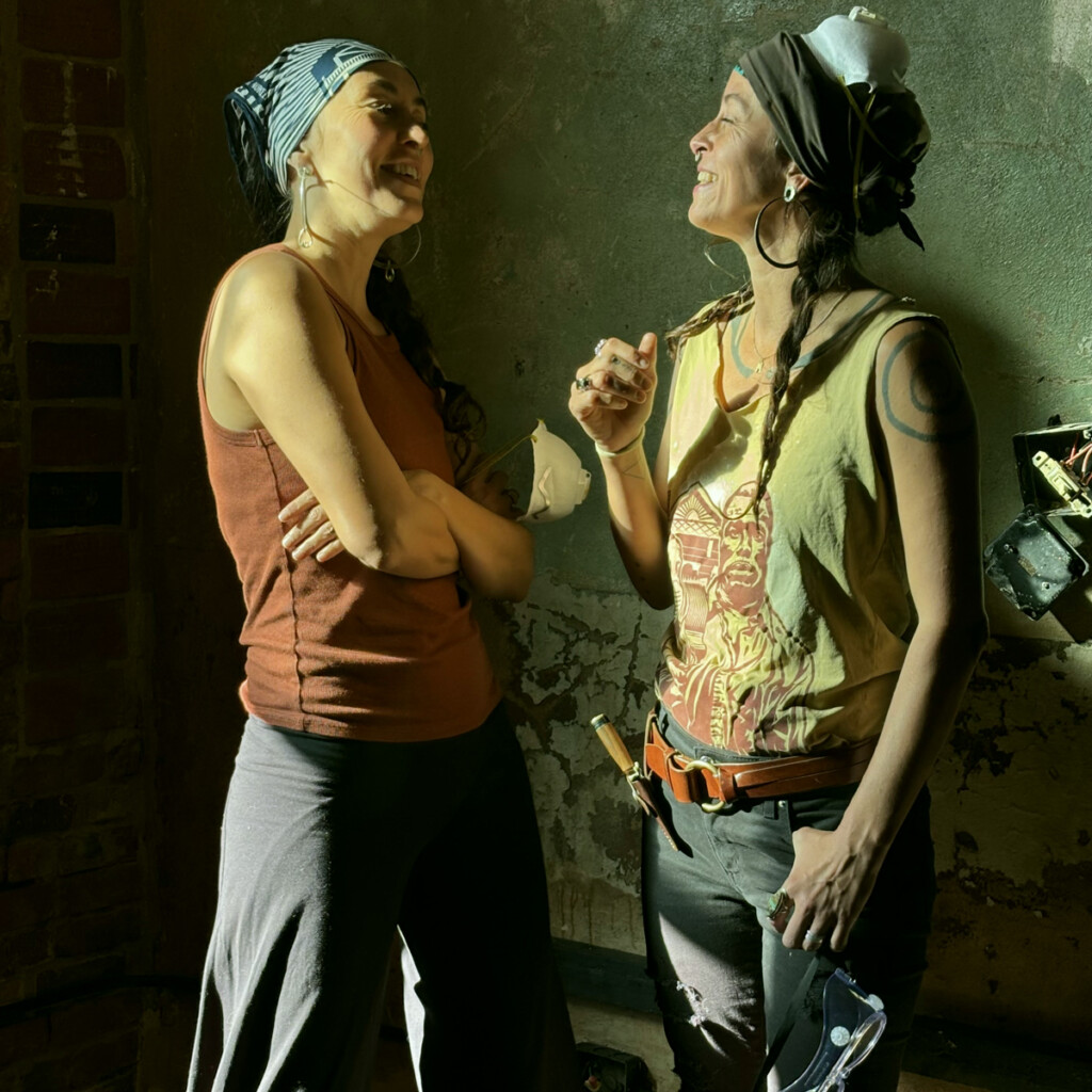 Chloe and Leah of Appalachia Rising singing in the Old Marshall Jail on Bridge Street, Marshall, after Hurricane Helene.