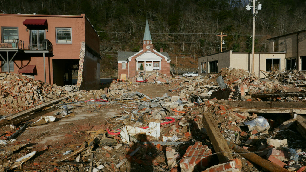 Debris field, my shadow and church in downtown Marshall, North Carolina, six months after Hurricane Helene.