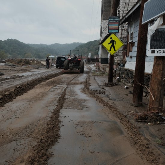 Mud from Hurricane Helene being scraped from Main Street, Marshall, North Carolina.