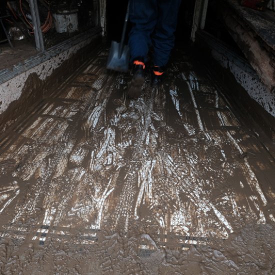 Mud on entrance to Bowman Hardware, Main Street, Marshall, North Carolina, from flooded French Broad River during Hurricane Helene.