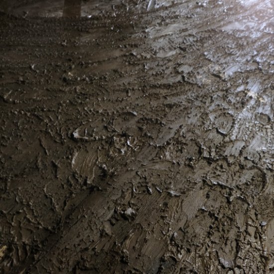 Mud lining floor of Every Angle Building Contractors, Back Street, Marshall, North Carolina, from flooded French Broad River during Hurricane Helene.