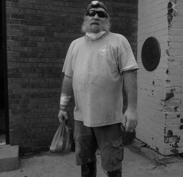 Large man in work clothes.