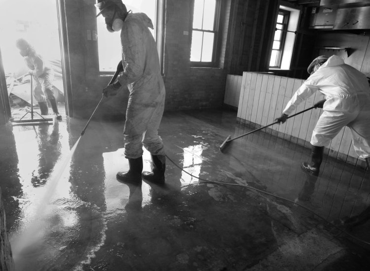 Pressure Washing and Sweeping Old Marshall Jail Hotel after Hurricane Helene.