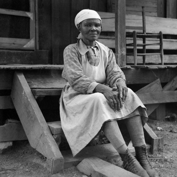 Woman sitting on porch steps. Photograph by O.N. Pruitt.
